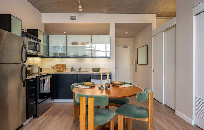 A modern kitchen with a table and chairs.