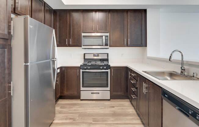 a kitchen with wooden cabinets and stainless steel appliances