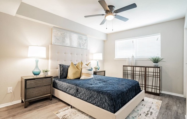 a bedroom with a bed and a ceiling fan