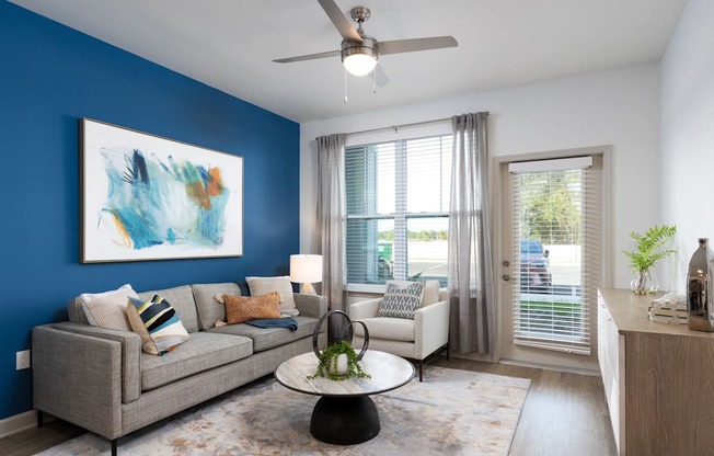 a living room with a blue accent wall and a couch