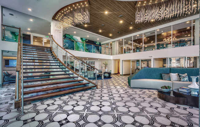 A large, open-concept living space with a staircase and a patterned floor.