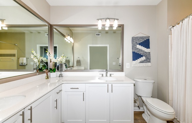 Renovated bathroom with large vanity and mirrors