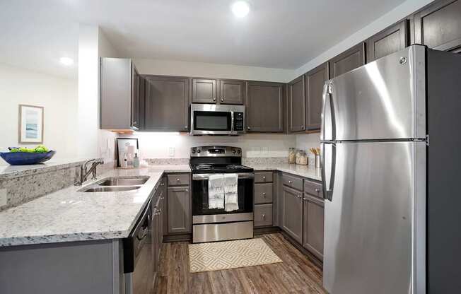 A modern kitchen with a stainless steel refrigerator.