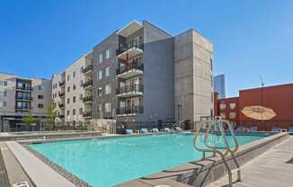 a swimming pool with a building in the background