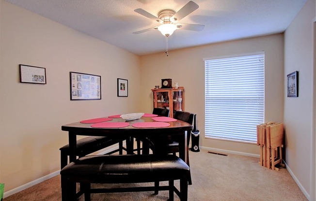 Image of dining room with table, chairs, and ceiling fan