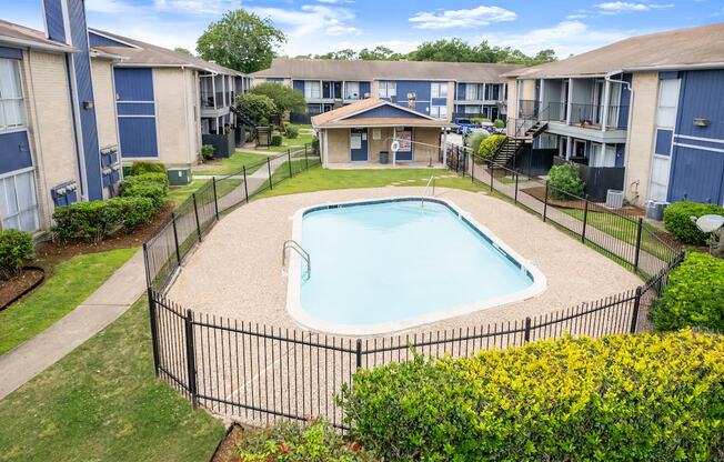 an aerial view of a swimming pool in an apartment complex