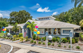a blue building with balloons in front of it at Aqua Bay Apartments in Naples, FL 34116