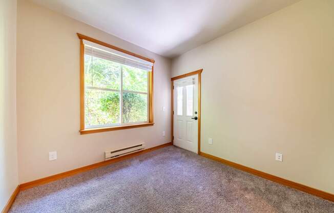 A room with a window and a door.