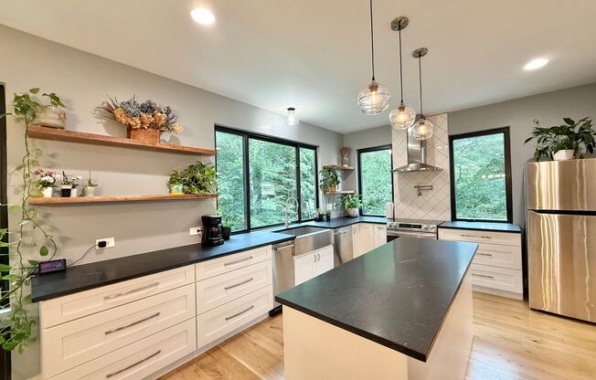 Incredible 5BD, 4.5BA Wake Forest Home Near Falls Lake with a Fully Finished Basement Living Space and a Backyard Haven Including a Large Deck, Fire Pit, and Creek