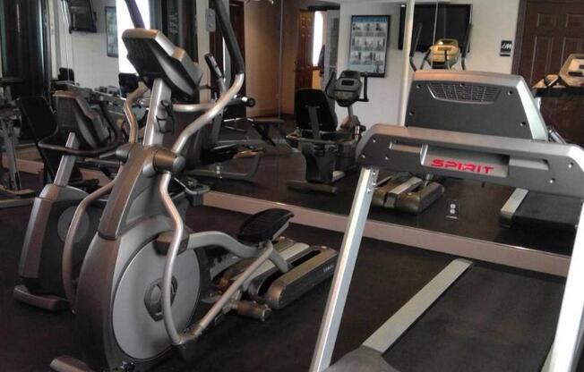 a room filled with lots of different types of exercise equipment