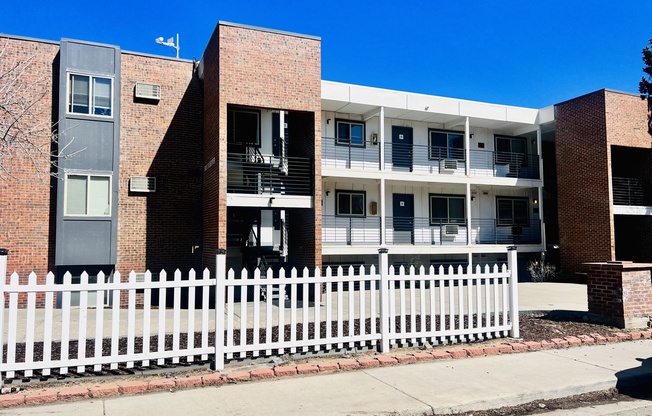 Contemporary apartment building exterior with brick and modern design features.