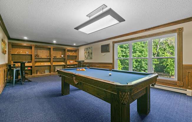 a game room with a pool table and a bar