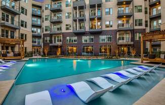 A large swimming pool with a blue light in the middle of it.