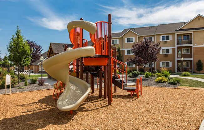a playground with a slide at Quail Springs Apartments