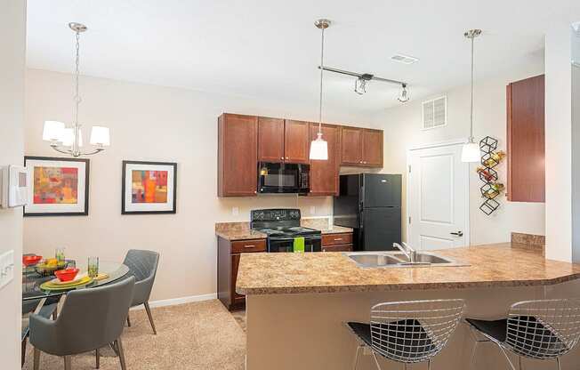 an open kitchen and dining area with a granite counter top