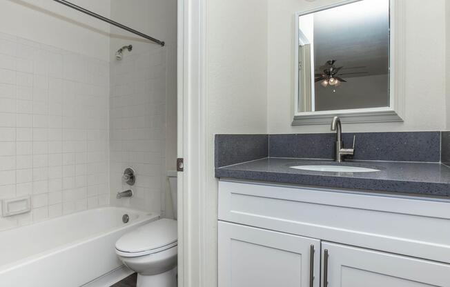 a room with a sink and a mirror