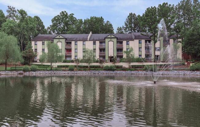 Apartment property pond with fountain and walking path