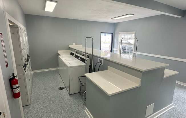 an empty room with a counter top and appliances in a building