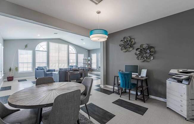 A modern dining room with a round table and chairs.
