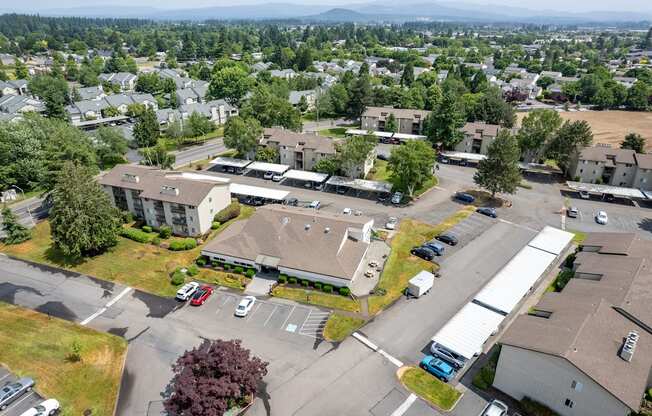 an aerial view of a community with several buildings and a parking lot