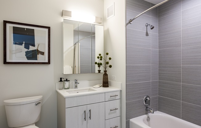 A bathroom with a white toilet, a white sink, and a white bathtub.