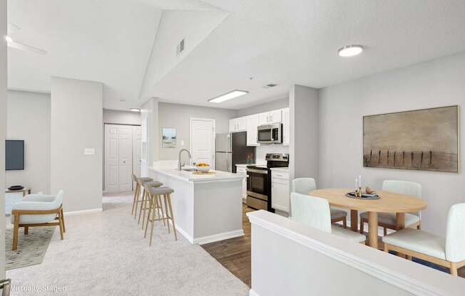 A modern kitchen with white cabinets and a dining table with chairs.