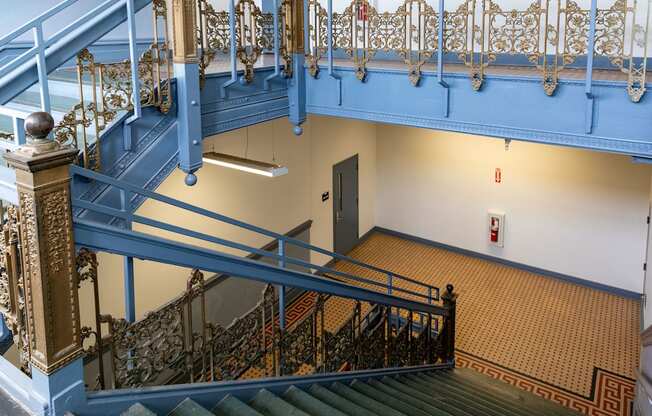 a view of the stairs in a building with blue railing and a door at Residences at South High, Pittsburgh, 15203 ? 