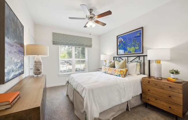 a bedroom with a bed and a ceiling fan