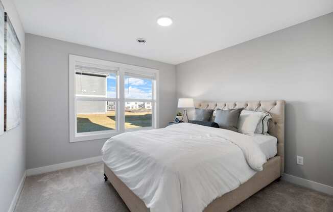 a bedroom with a large bed and a window