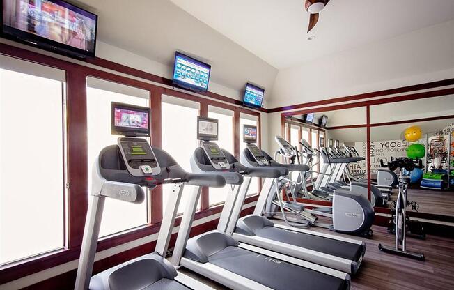 A gym with treadmills and exercise bikes.