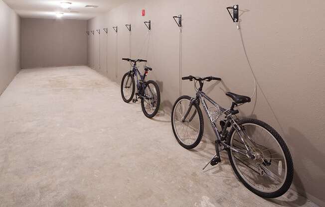 bike storage room with two bikes chained to the wall security system