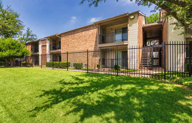 Apartment building exterior at Canyon Creek Apartments in the Midtown neighborhood of Dallas, TX.