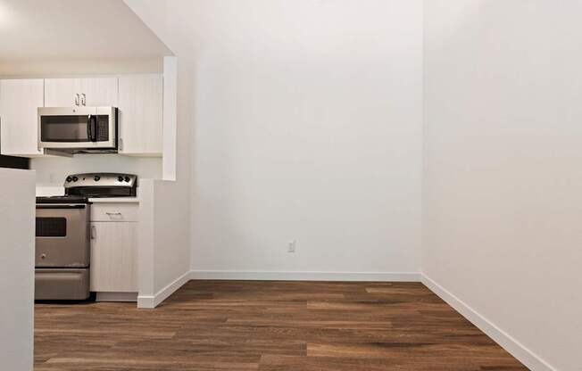 A kitchen with a microwave and oven built into the cabinetry.