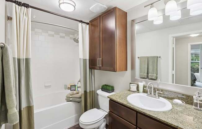 A bathroom with a toilet, sink, and shower.