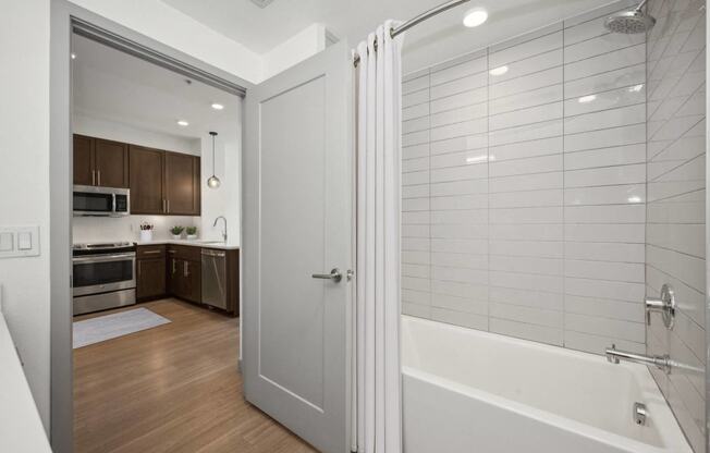 a bathroom with a shower and a sink in a room