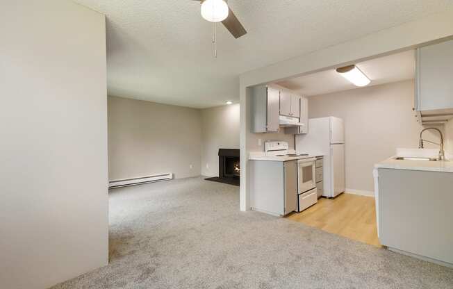 A kitchen area with a refrigerator, sink, and oven.