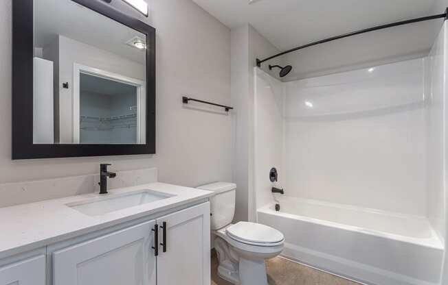 a bathroom with a sink toilet and bathtub
