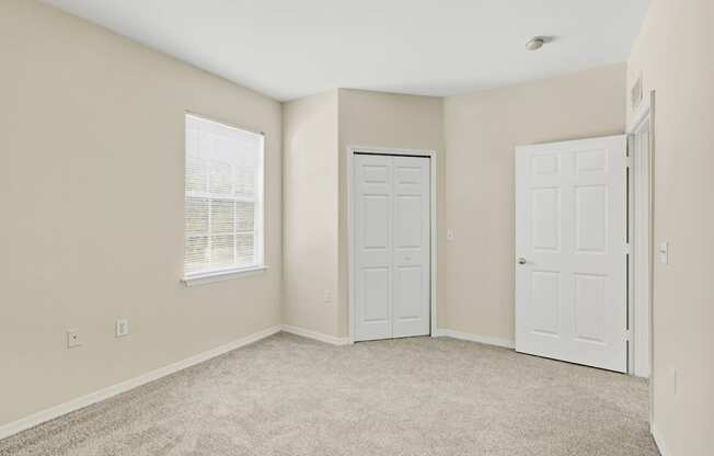 A room with two doors and a window.