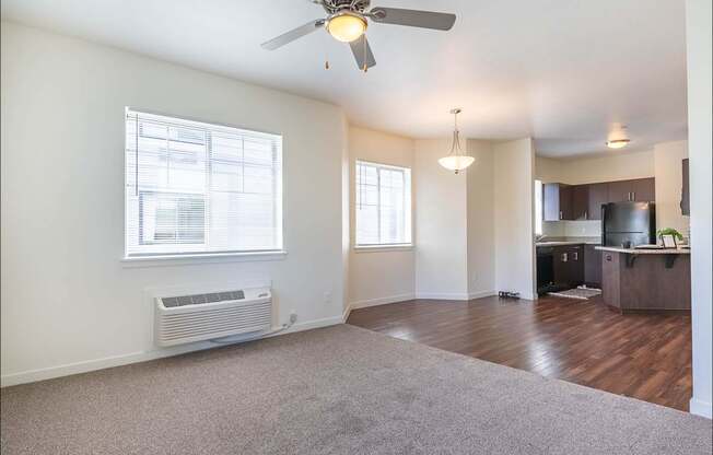 A room with a ceiling fan and a window with blinds at Riverplace Apartment Homes, Independence, OR, 97351
