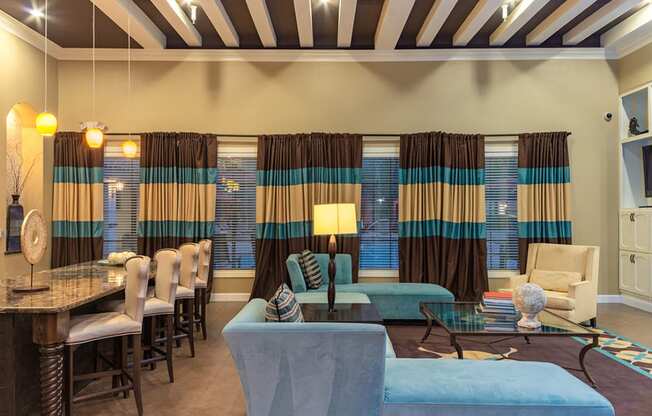 a living room filled with furniture and a large window