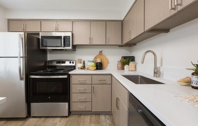 a kitchen with stainless steel appliances and white counter tops