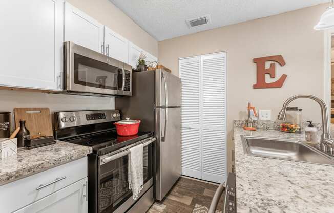 a kitchen with stainless steel appliances and granite counter tops