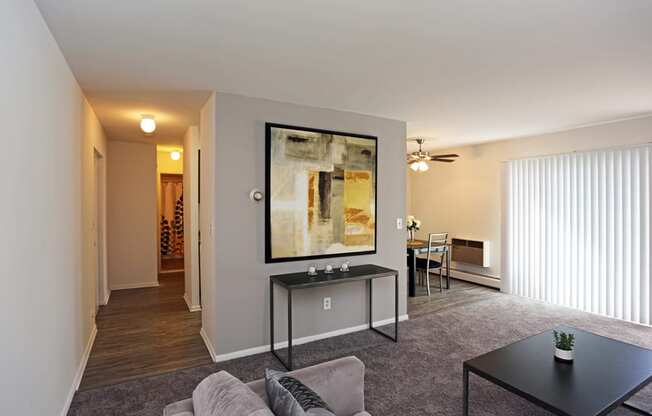 a living room with a couch and a coffee table in front of a large window