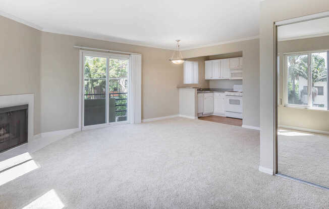 Carpeted Living Room with Balcony and Fireplace