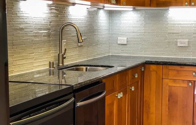 Napili Towers kitchen area with appliances, cabinets, and counters