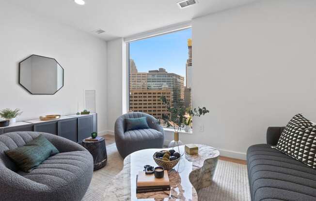 a living room with a large window and a couch and a coffee table