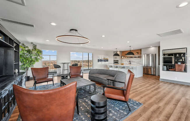 A modern living room with brown leather chairs and a wooden floor.