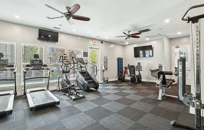 A spacious gym with treadmills, elliptical machines, and other exercise equipment.