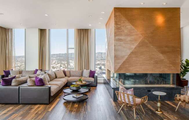 A modern living room with a fireplace and a view of the city.