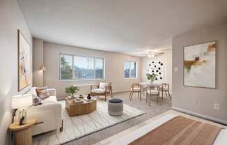 A living room with a white couch, a wooden coffee table, and a large painting on the wall.